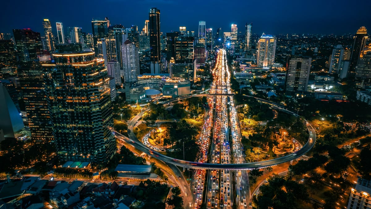 Jakarta night highway interchange — tax residency