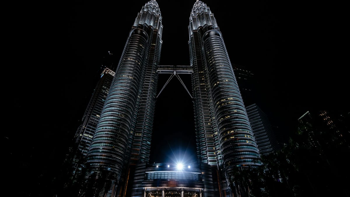 Petronas Twin Towers at night in Kuala Lumpur — Malaysia stay, earn and tax hub