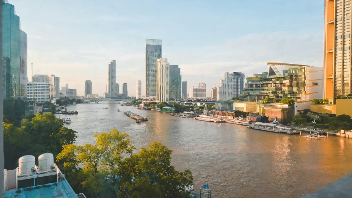 Bangkok river CBD at dusk — tax residency