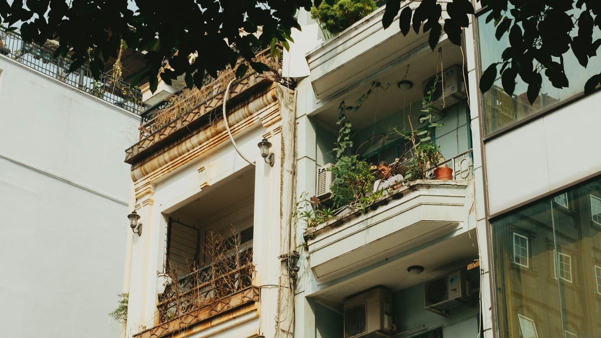 Apartment balconies with plants and air conditioners in Ho Chi Minh City