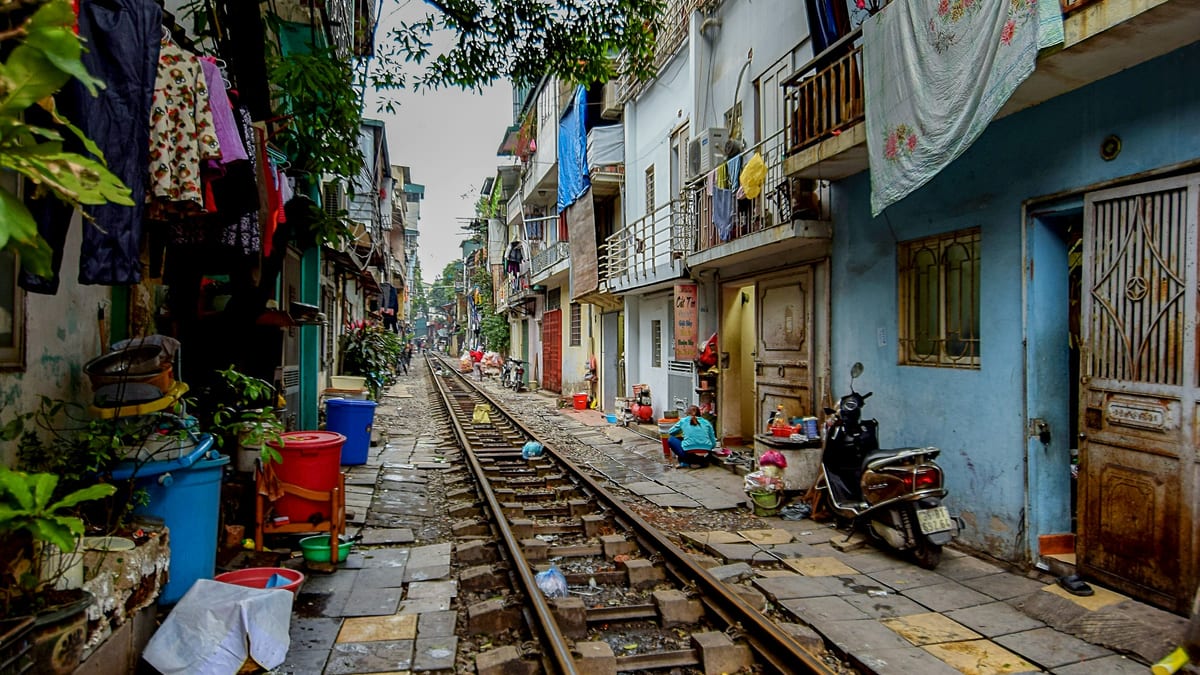 Hanoi Train Street residential alley with laundry and household buckets