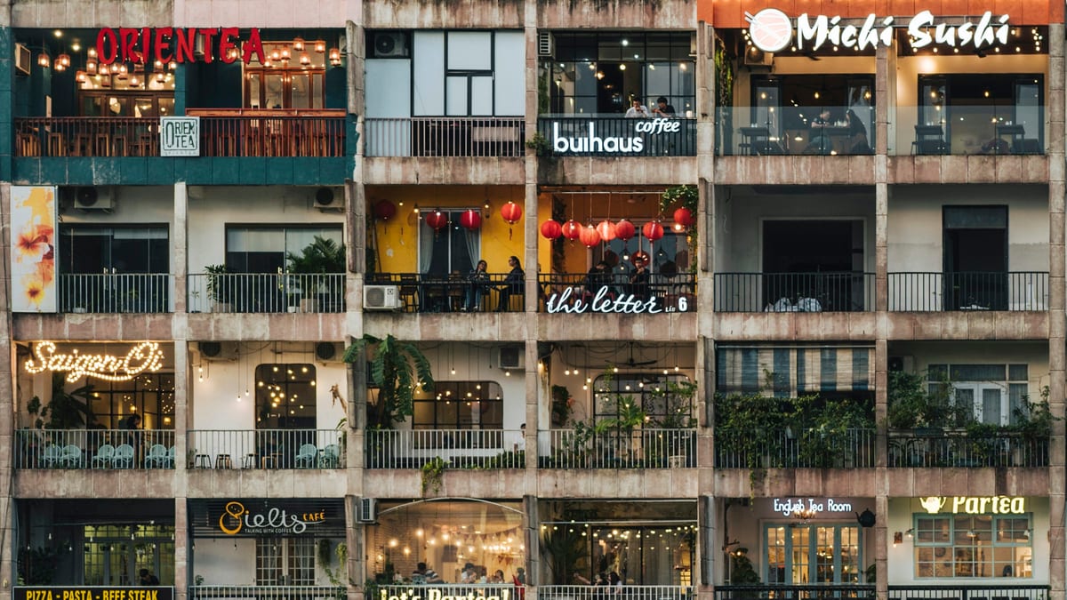 Cafe Apartment balconies lit at dusk on Nguyen Hue in Ho Chi Minh City